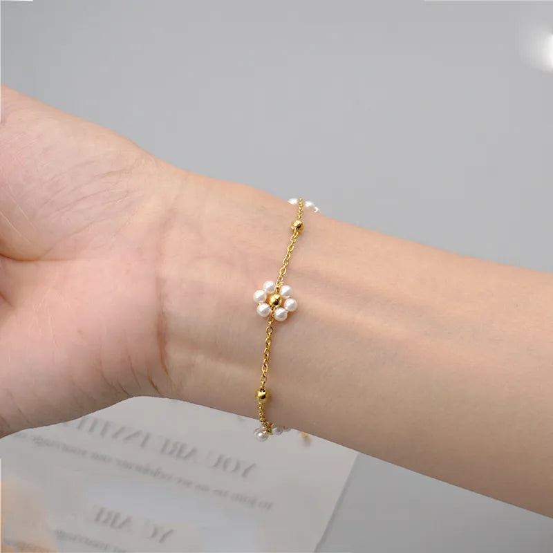 Filigranes Edelstahl Gold Armband mit weißen Blumen